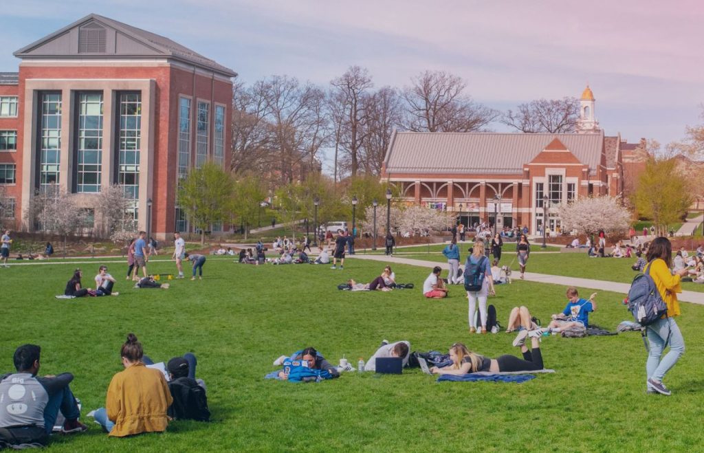 Students sitting on and walking around the Student Union Quad.